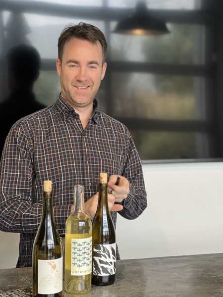 Cormorant winemaker Charlie Gilmore opening some bottles